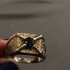 Men’s silver ring with sapphire gem in center